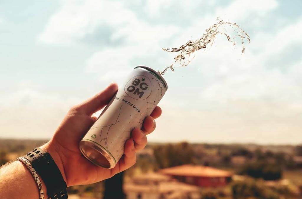NATURALBOOM health drink in can being opened outdoors