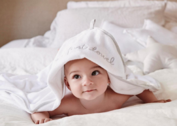 baby peeking through baby clothes