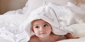 baby peeking through baby clothes